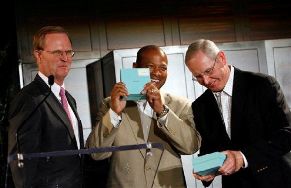New York Giants co-owner John Mara, left, presents general manager Jerry Reese, center, and head coach Tom Coughlin, right, with their Super Bowl rings at Tiffany.